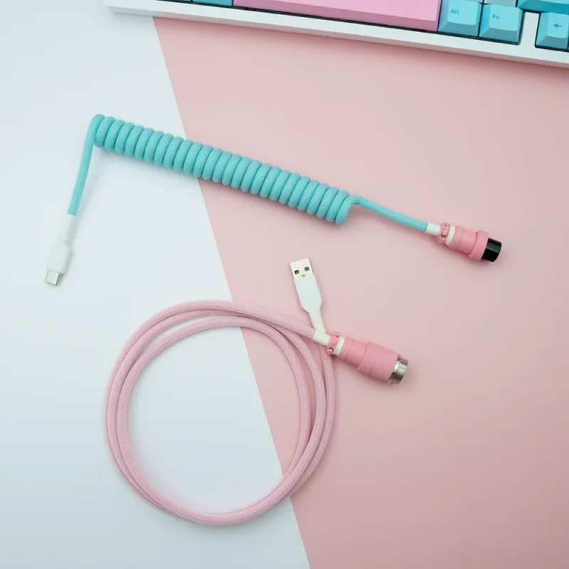 Custom keyboard cable features a coiled aqua blue section and a straight pink part. It includes USB-C and aviator connectors, showcasing quality braiding.