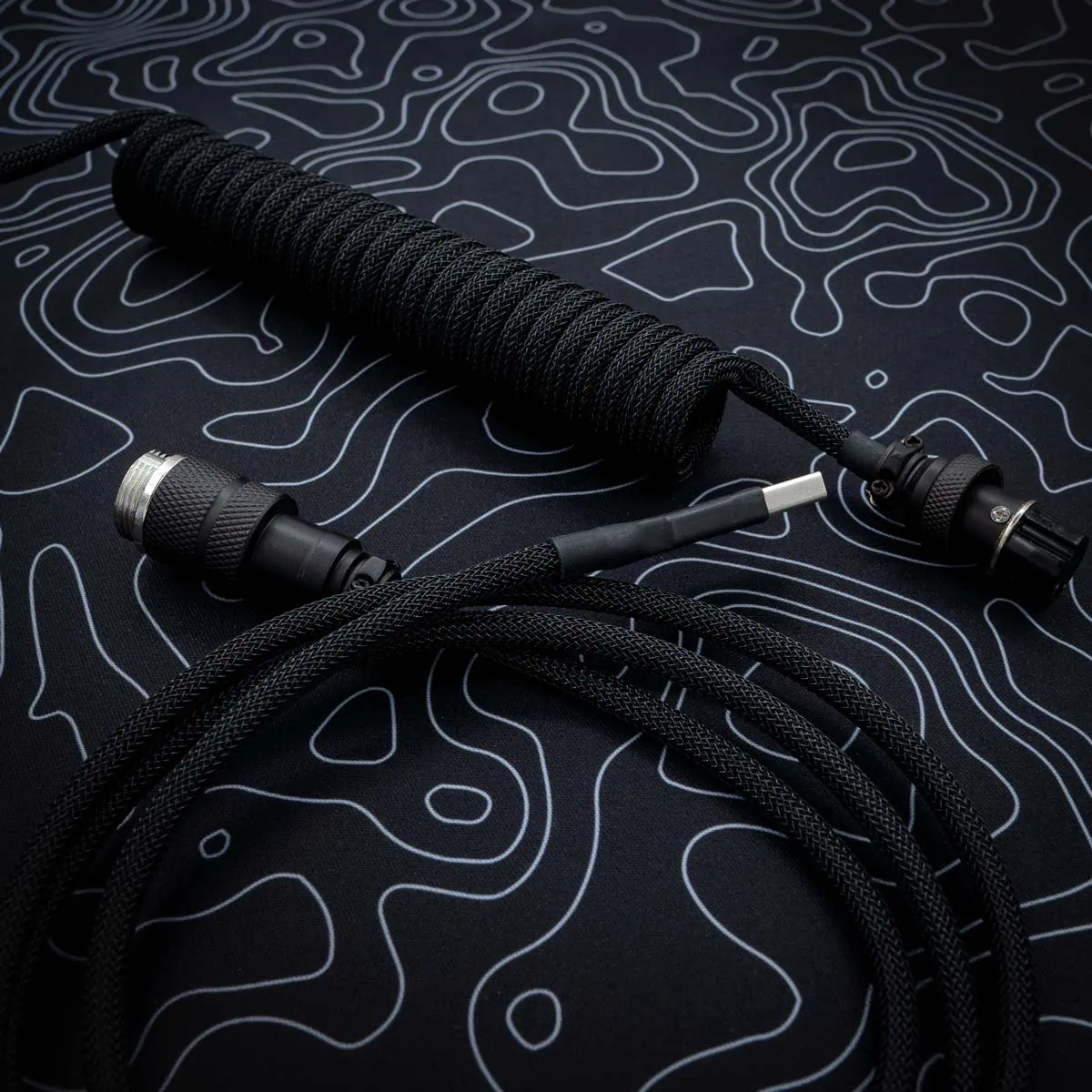 Black coiled cable Custom black keyboard cable featuring a coil section, USB connectors, and high-quality paracord braiding. Ideal for enhancing your setup.