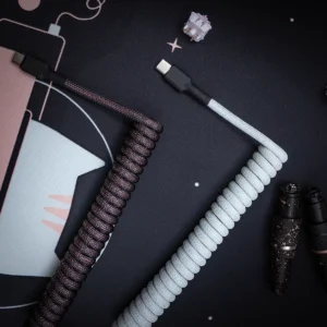 Black white coiled cables usb c top view Stylish GMK Olivia keyboard cable featuring a coiled design in dark and light colors, USB-C connectors, premium paracord finish, and durable heatshrink.