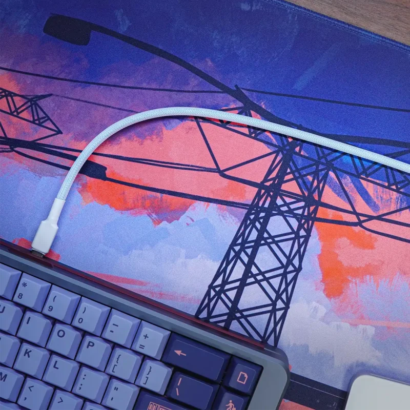 Blue custom straight keyboard cable A close-up of a keyboard corner and a Blue custom straight keyboard cable on a mouse pad illustrated with power lines against a vibrant orange