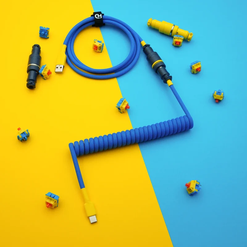 Blue yellow coiled cable usb c top view Bright blue custom keyboard cable featuring a coiled design