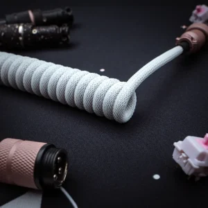 Coiled white cable angled gx16 connector Stylish white coiled keyboard cable with a smooth texture, featuring detachable plugs, quality braiding, and durable connectors for a sleek setup.