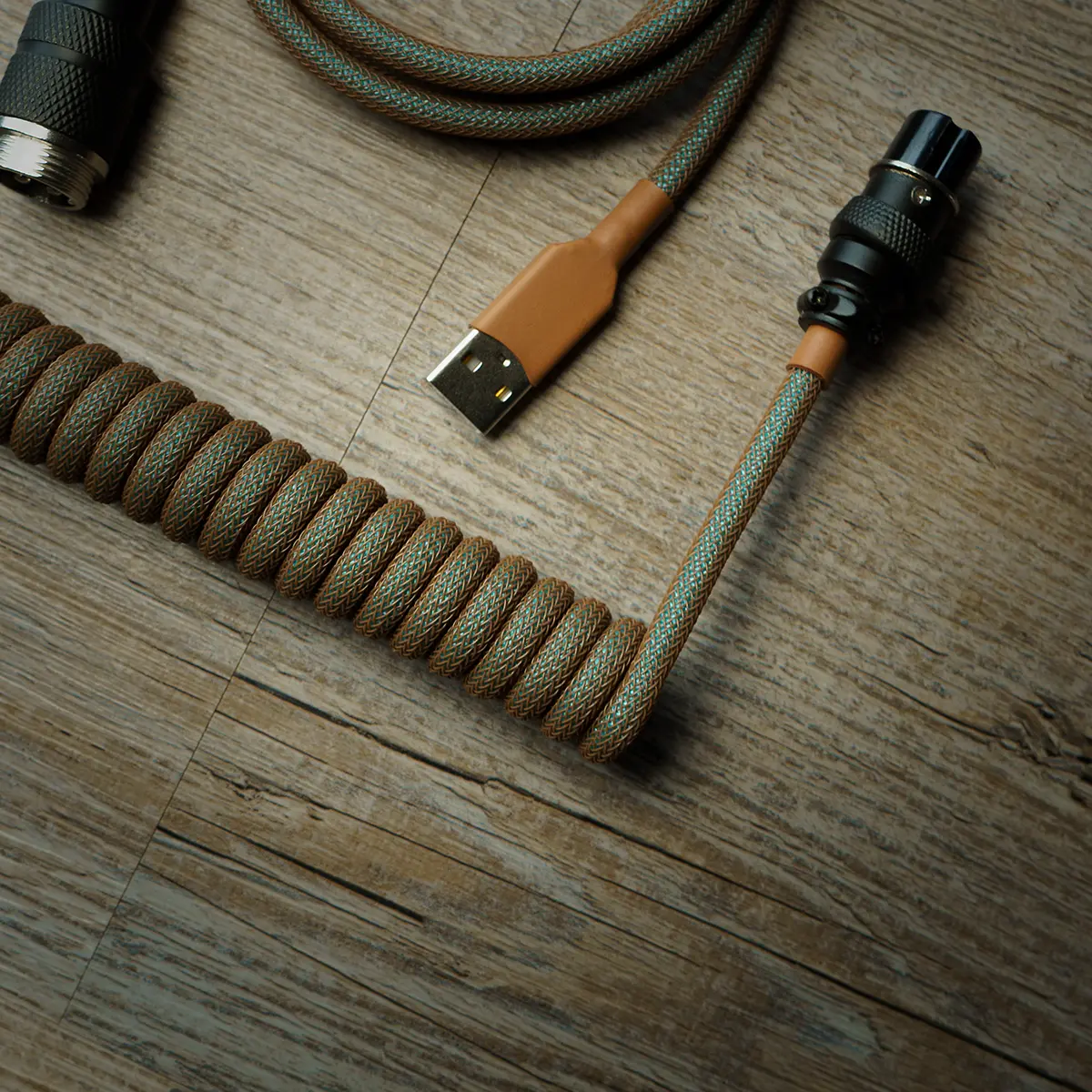 Copper usb aviator coiled cable top view Custom GMK Copper Keyboard Cable featuring a coiled design, USB connector, and braided paracord in earthy tones for enhanced durability and style.