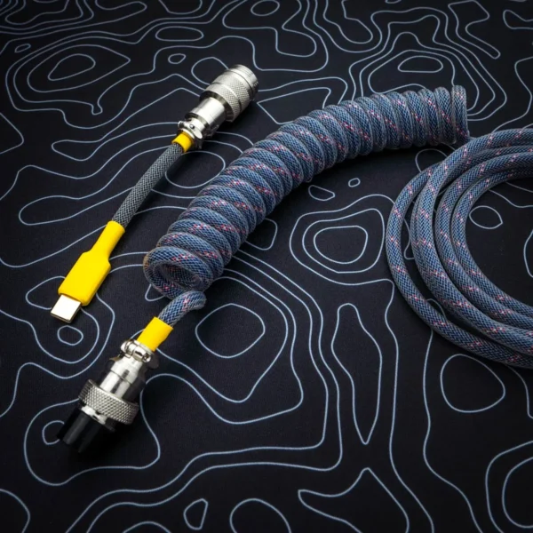 Dark blue coiled cable overhead usb c A dark blue coiled keyboard cable featuring a USB-C connector with a yellow accent