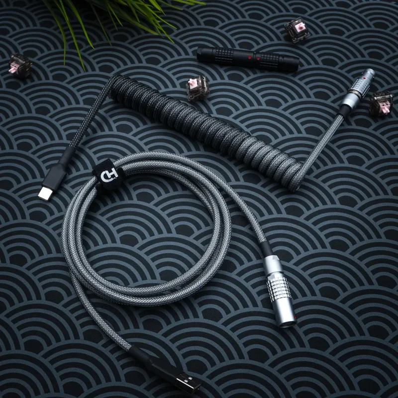 Dark gray coiled cable overhead lemo like Dark gray keyboard cable featuring a coiled design