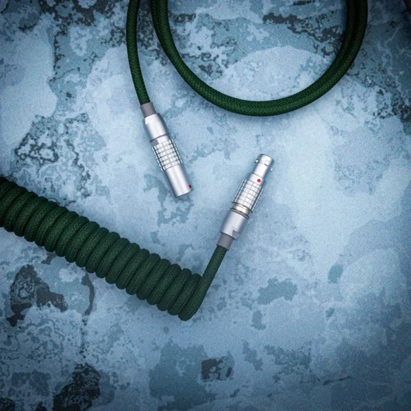 Green coiled cable lemo like connectors overhead Coiled green paracord keyboard cable featuring detachable metal connectors, ideal for customizable setups; showcases premium braiding and sleek finish.