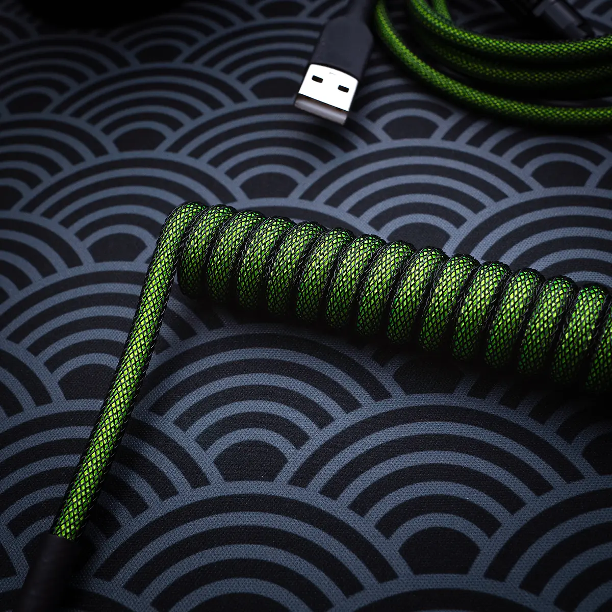 Green coiled keyboard cable usb angled Custom green keyboard cable featuring a coiled design with high-quality braiding. Includes a USB connector and textured heatshrink for durability.