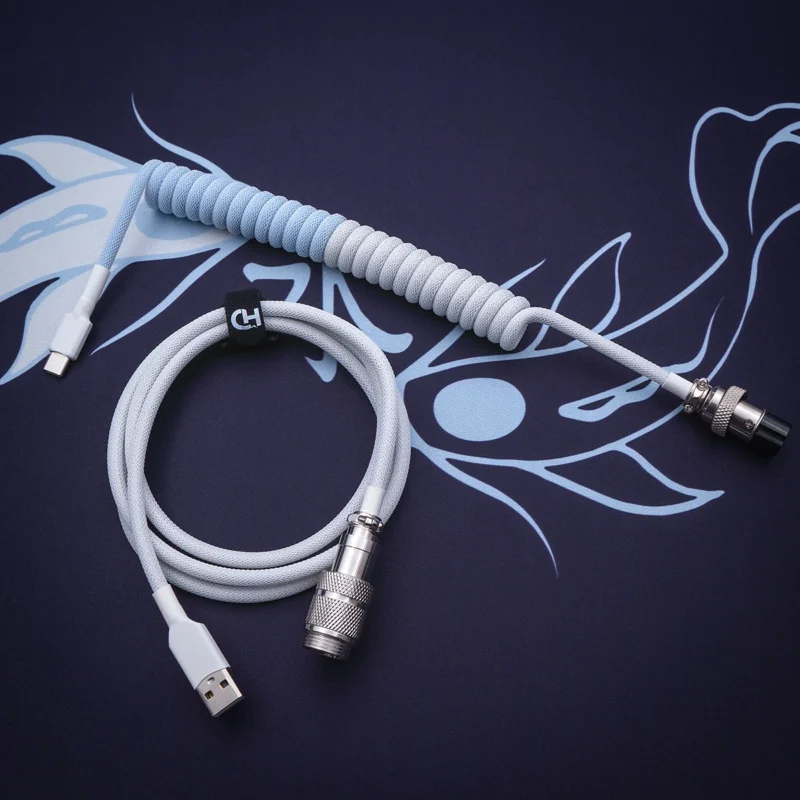 Light blue coiled cable overhead usb c Custom keyboard cable featuring a coiled design in a soft blue and gray color scheme. Includes USB-C and aviator connectors with durable braiding and quality finish.
