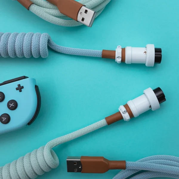 Light blue coiled cable usb aviator overhead Coiled PBT Islander keyboard cable features a light blue and brown paracord design, USB-C and aviator connectors with durable CNC metal housing, perfect for custom setups.