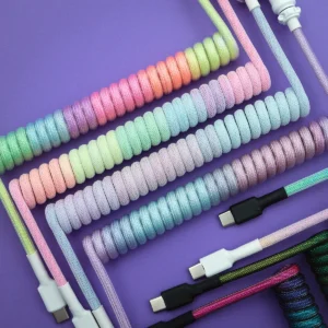 Pastel rainbow coiled cables usb c top view Colorful custom keyboard cables feature various coils and textures, including USB-C connectors and detachable plugs, showcasing vibrant, braided designs.