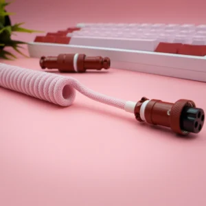 Pink coiled cable gx16 connector closeup A coiled pink keyboard cable featuring detachable aviator connectors, showcasing braided techflex, and high-quality metal housing for durability.