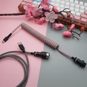 Pink gray coiled cable overhead gx16 connector Coiled pink paracord keyboard cable with USB-C and aviator connectors. Features quality braiding and detachable plugs for flexibility and style.