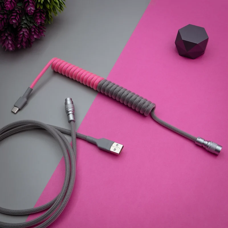 Pink gray coiled cable usb c angled shot Coiled keyboard cable with pink and gray paracord