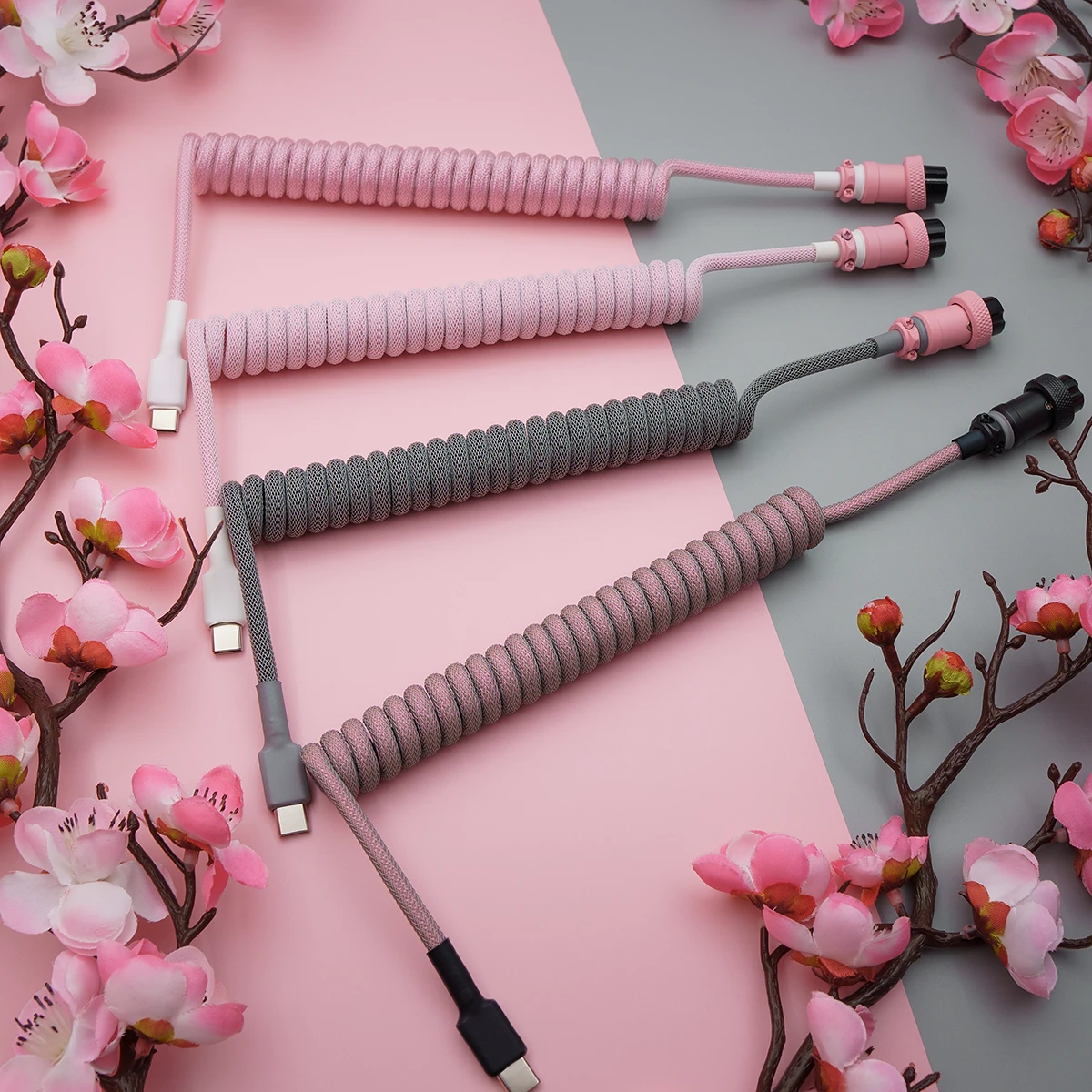 Pink gray coiled cables overhead sakura A stylish array of coiled keyboard cables in pink and gray