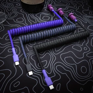 Purple black coiled cables usb c top view Custom keyboard cables featuring coils in purple and black paracord, USB-C connectors, and sleek detachable plugs, designed for style and durability.