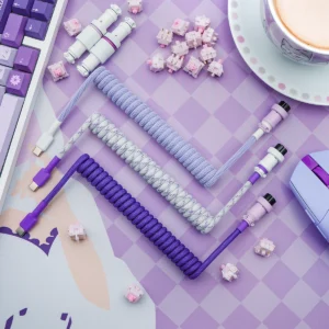 Purple coiled cables overhead usb c connectors A set of custom keyboard cables featuring coiled designs in purple and lavender