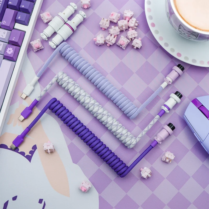 Purple coiled cables overhead usb c connectors A set of custom keyboard cables featuring coiled designs in purple and lavender