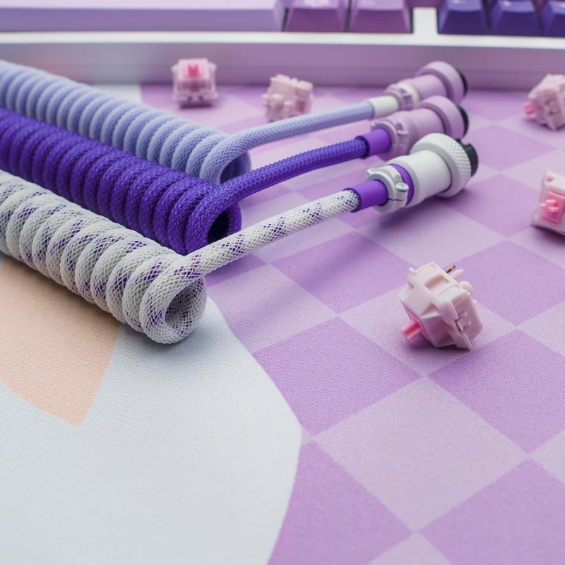 Purple coiled cables usb c angled view Custom keyboard cables in purple and white paracord, featuring coiled sections, detachable connectors, and high-quality CNC metal housing.