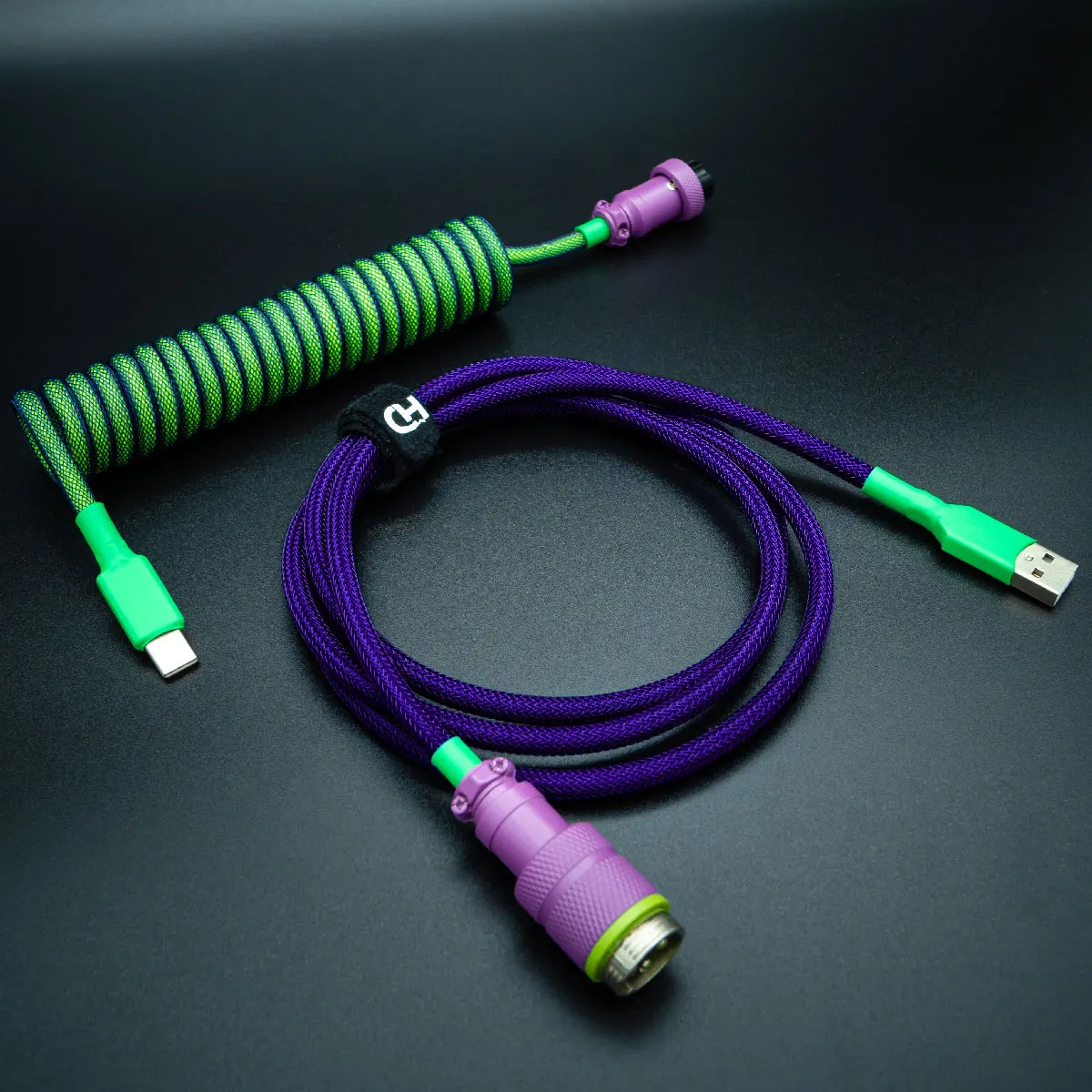 Purple green coiled usb c aviator angled Custom Joker Keyboard Cable featuring a vibrant coil design in green and purple, USB-C connectors, detachable plugs, and durable paracord braiding for added style.