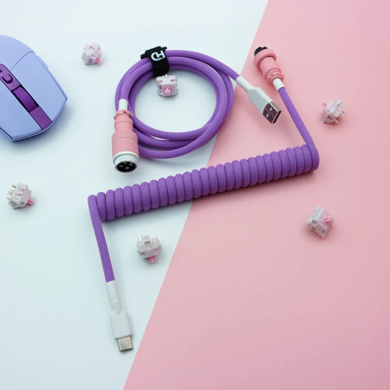 Purple pink coiled cable usb c overhead Purple coiled keyboard cable featuring a USB-C connector