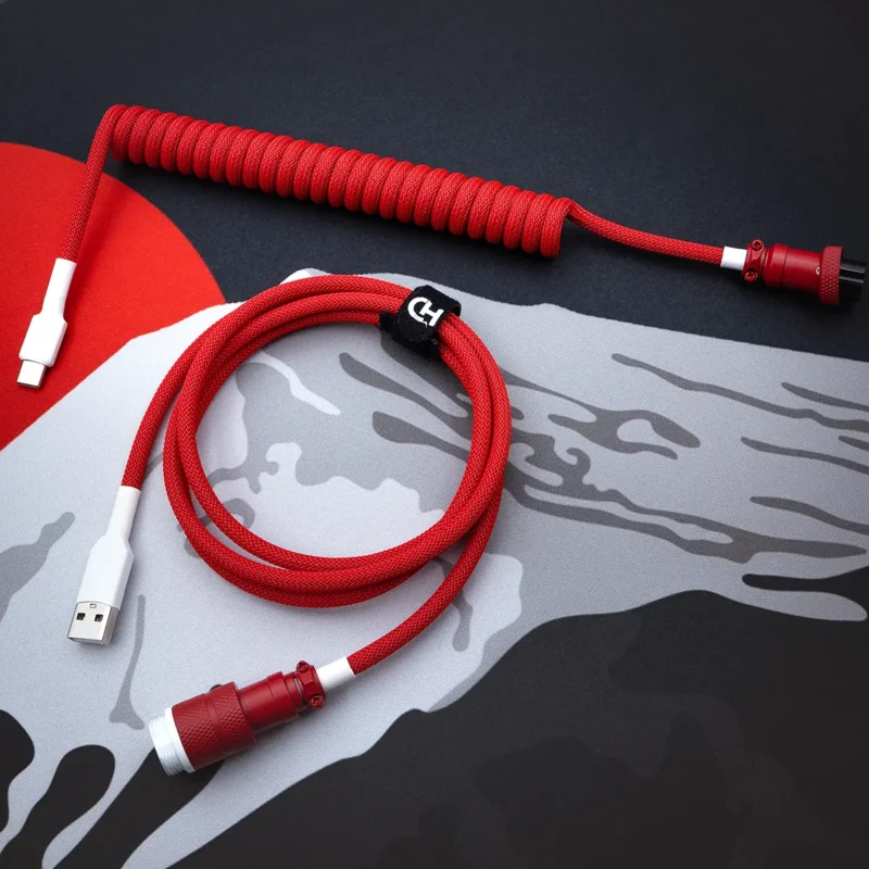 Red coiled keyboard cable overhead aviator A vibrant red GMK Jamon cable features a coiled design with a USB-C connector and a detachable aviator plug
