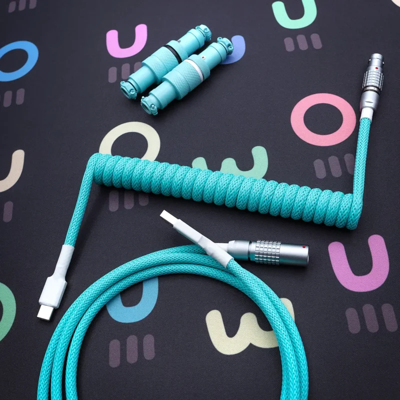 Teal coiled cable overhead lemo connectors A vibrant turquoise coiled keyboard cable featuring detachable USB-C and aviator connectors