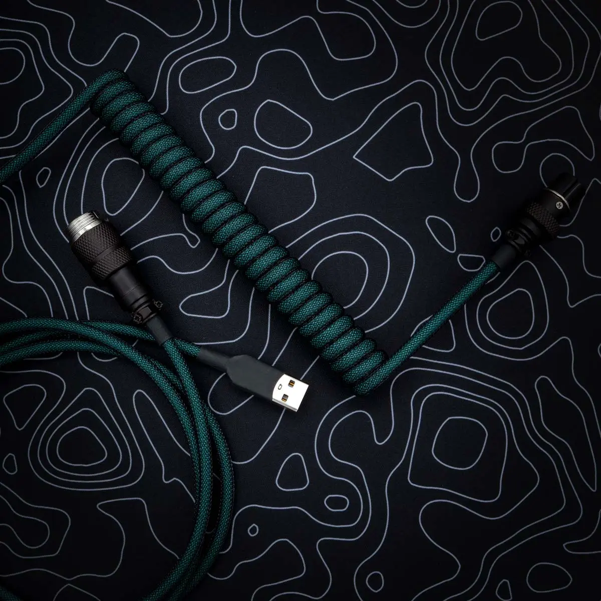 Teal coiled cable usb angled aviator Green coiled keyboard cable features a USB-C connector and a detachable aviator plug. The paracord texture enhances durability and style.