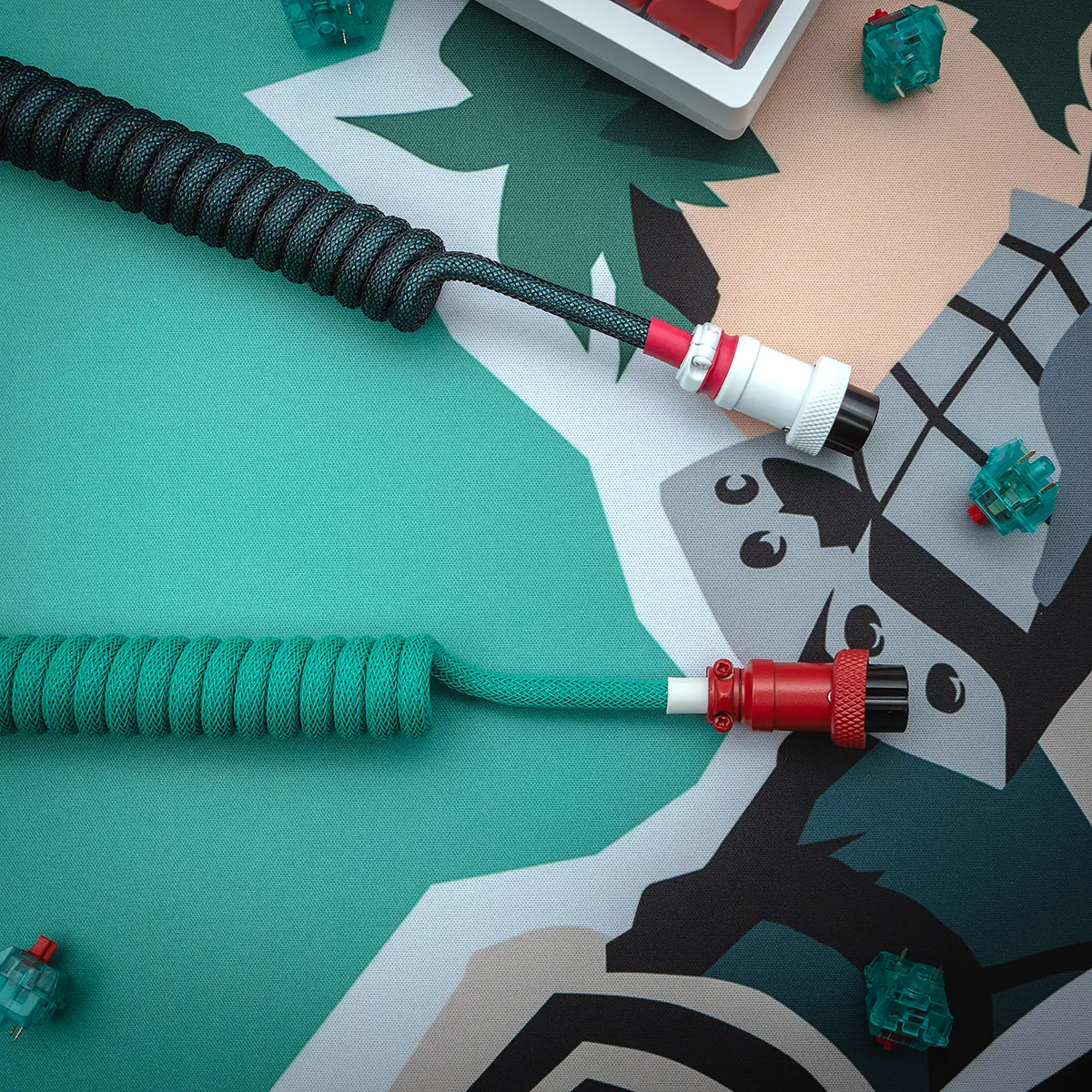 Teal red coiled cables overhead gx16 connectors A vibrant GMK Deku keyboard cable featuring a coiled design, detachable connectors, and high-quality braiding in teal and black. Perfect for customization!