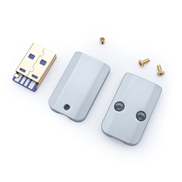 Disassembled USB device featuring a USB A connector, two silver USB A Housing CNC - V2 casing pieces, and three small screws on a white background.