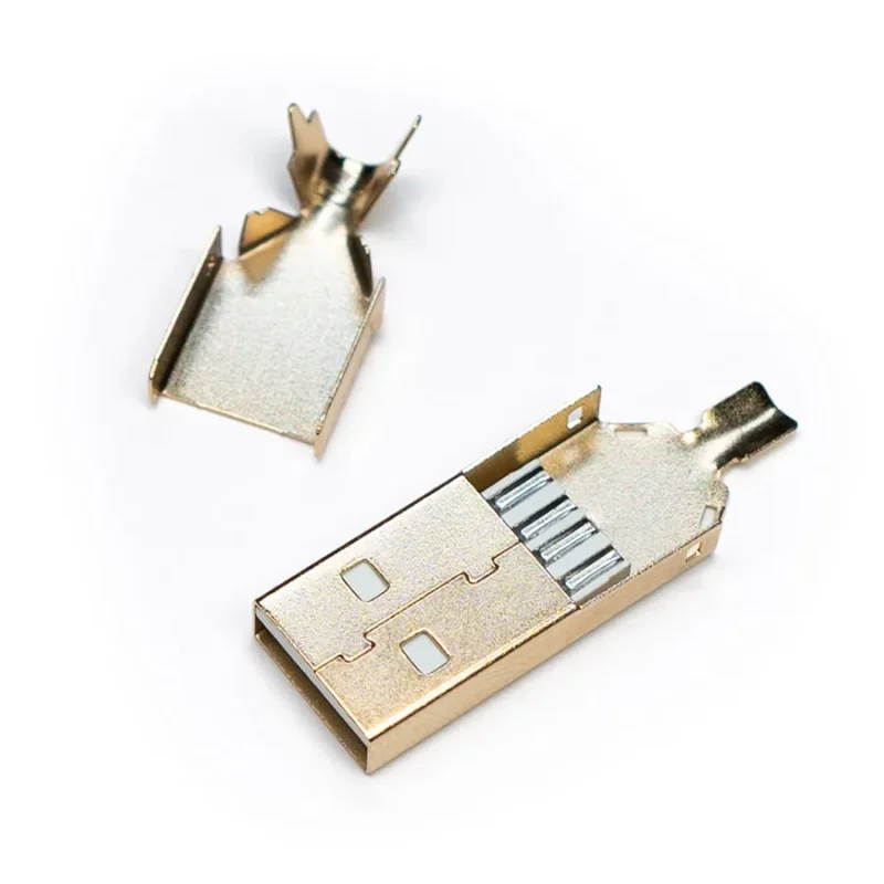 Usb a connector gold part A disassembled USB 2.0 Type A - Solder Connector shell is shown with its top and bottom gold metal halves separated on a white background.