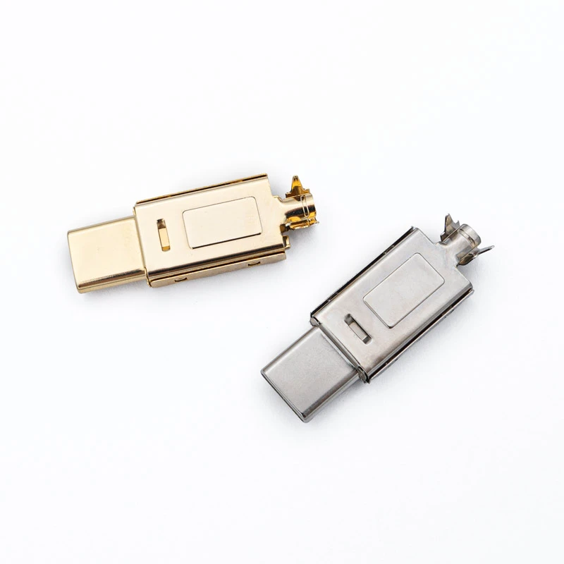 Usb c connector silver gold shell 2 assembled USB Type C connectors with metal casings and are arranged on a white background.