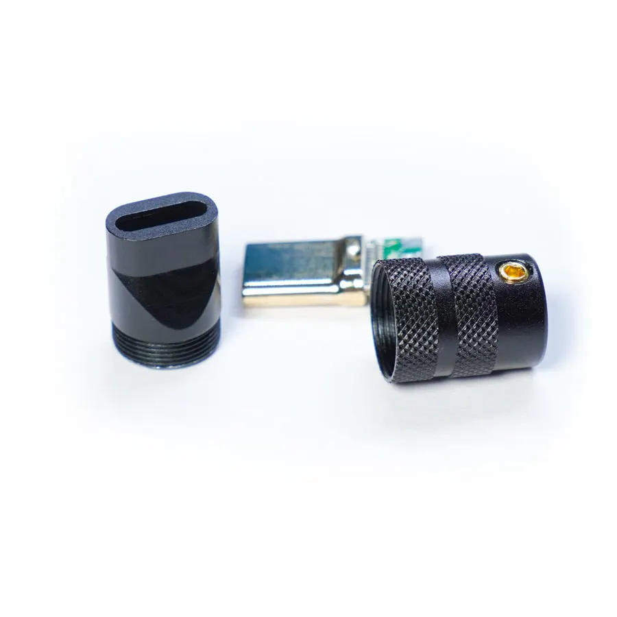 Usb typec connector housing cnc black 1 Three cnc shell components, including a black USB Type C connector, and a black metal piece with Housing CNC precision, are displayed on a white background.