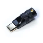 Usb typec connector housing cnc black A close-up of a metallic USB Type C featuring black Housing CNC precision, with a textured grip and a gold-plated connector, photographed on a light background.