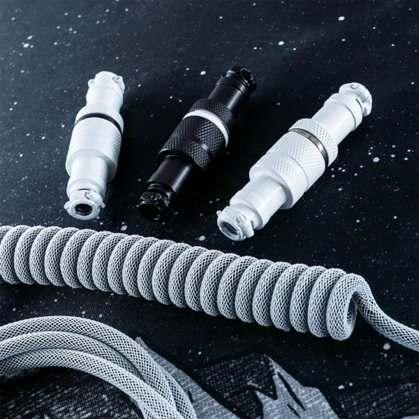 White black connectors coiled cable overhead Coiled white custom keyboard cable featuring detachable USB connectors in black and white. Durable paracord and textured finish enhance quality.