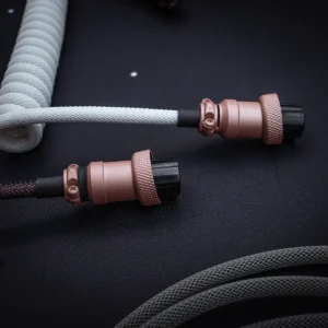 White coiled cable rose gold connectors Coiled GMK Olivia keyboard cable features a sleek paracord finish, dual detachable plugs (USB-C and aviator), and premium CNC metal housing for durability.