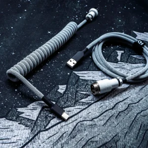 White on black coiled cable usb c gx16 top view Coiled white and black keyboard cable with USB-C and gx16 aviator white connector. Features durable techflex braiding