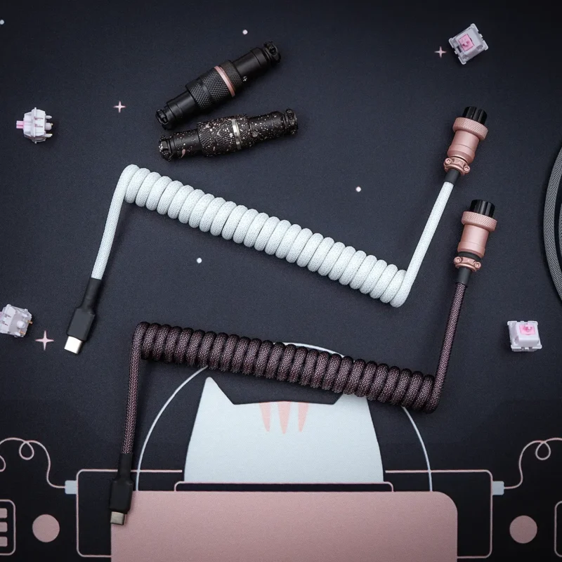 White pink coiled cable usb c top view Custom keyboard cables in white and dark brown, featuring coiled designs, USB-C connectors, detachable plugs, and quality paracord braiding for durability.